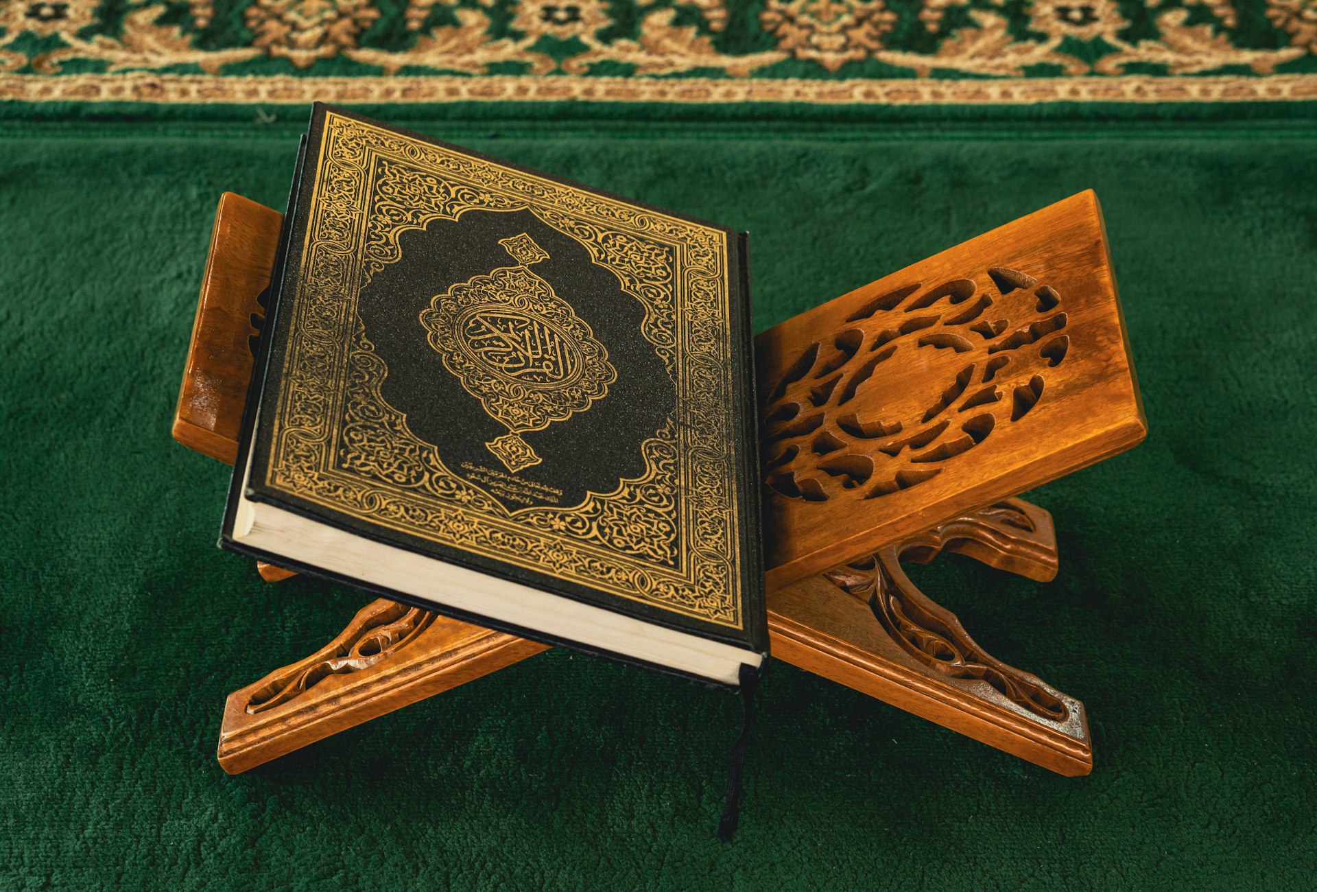 An open book sitting on top of a wooden stand